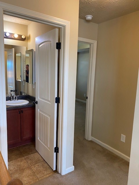 bathroom featuring vanity and a textured ceiling