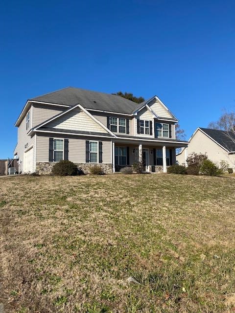 view of front of home with a garage and a front yard