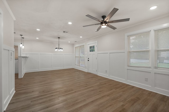919 54th St, Columbus, GA 31904 - spare room featuring a decorative wall, ornamental molding, wood finished floors, a chandelier, and ceiling fan