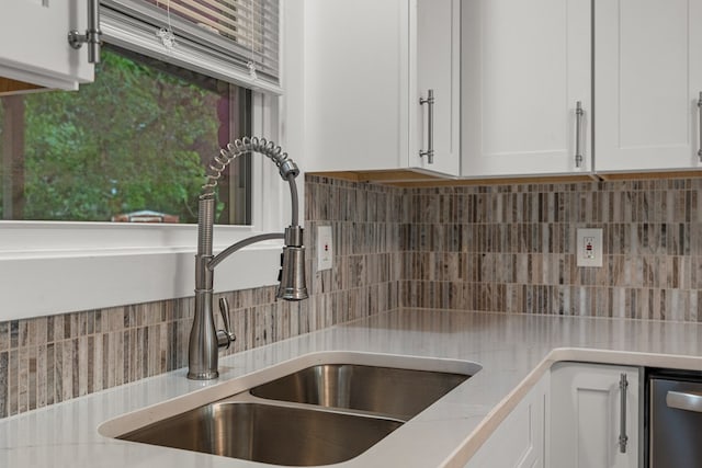 919 54th St, Columbus, GA 31904 - kitchen featuring backsplash, light countertops, white cabinetry, and stainless steel dishwasher
