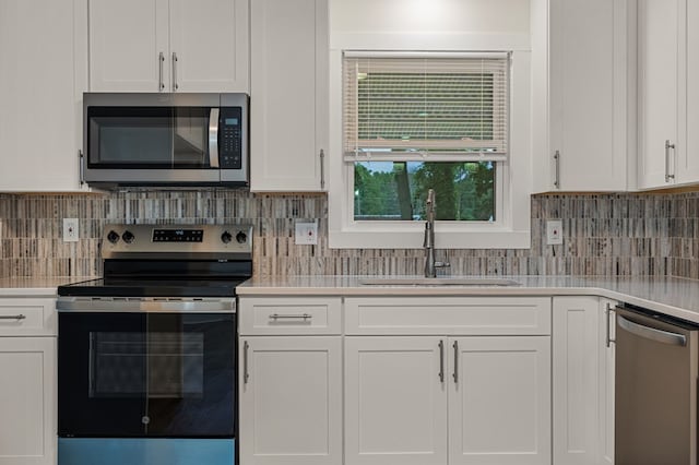 919 54th St, Columbus, GA 31904 - kitchen featuring stainless steel appliances, light countertops, and white cabinets