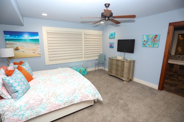 carpeted bedroom featuring ceiling fan and ensuite bathroom