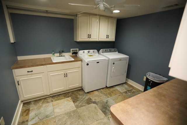 clothes washing area with ceiling fan, cabinets, independent washer and dryer, and sink