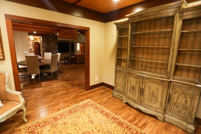 hallway featuring wood-type flooring and wooden ceiling