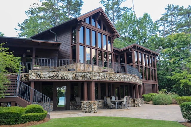 rear view of house with a patio area and a balcony