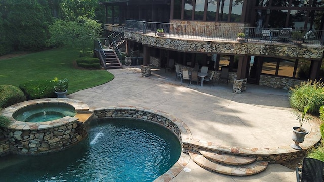 view of swimming pool featuring a patio area, an in ground hot tub, and a yard