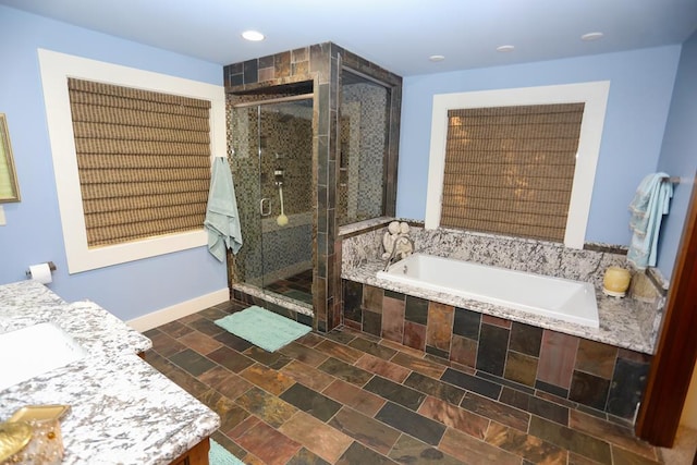 bathroom featuring vanity and plus walk in shower