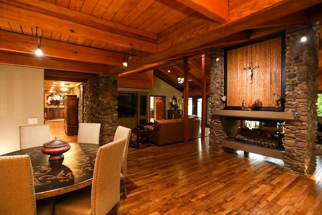 dining room featuring hardwood / wood-style flooring, a fireplace, wooden ceiling, and rail lighting