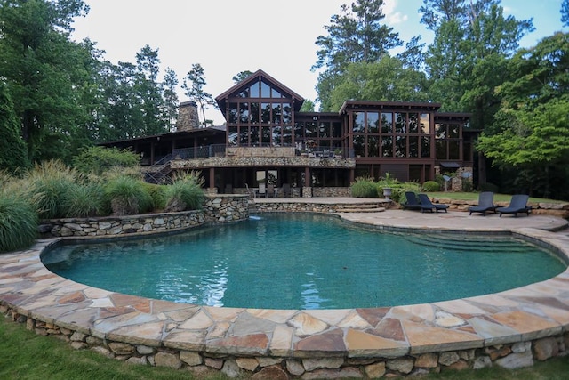 view of swimming pool with a patio and a wooden deck