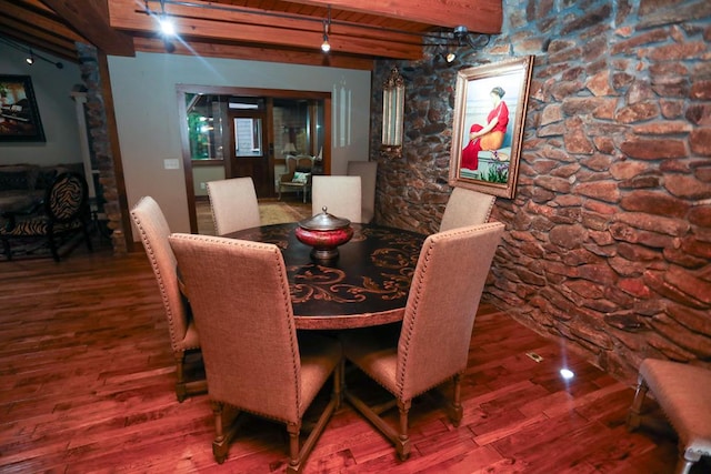 dining area featuring wooden ceiling, beamed ceiling, and wood-type flooring