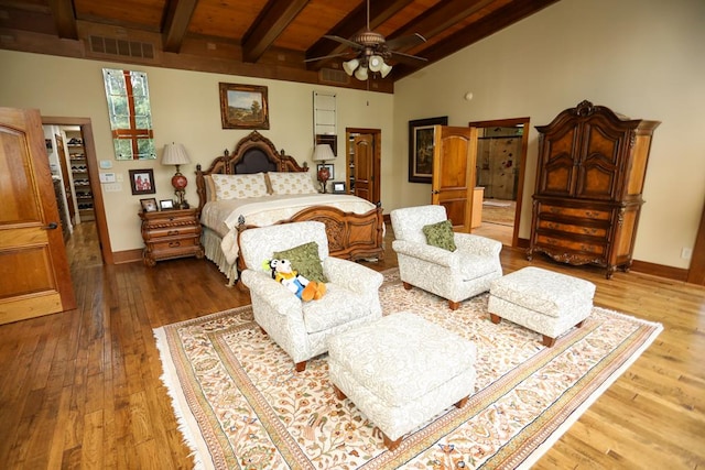 bedroom featuring high vaulted ceiling, hardwood / wood-style flooring, ceiling fan, beam ceiling, and wood ceiling