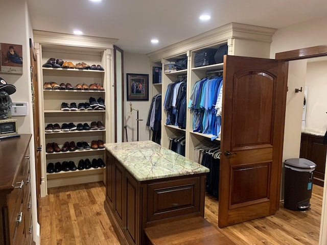 spacious closet featuring light hardwood / wood-style floors