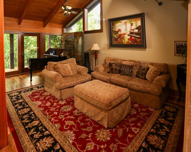 living room featuring hardwood / wood-style flooring, lofted ceiling with beams, a healthy amount of sunlight, and wooden ceiling