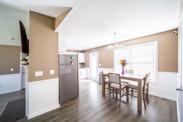 2 Alexander Loop, Phenix City, AL 36869 - dining area featuring a chandelier, dark wood-type flooring, wainscoting, a textured ceiling, and healthy amount of natural light