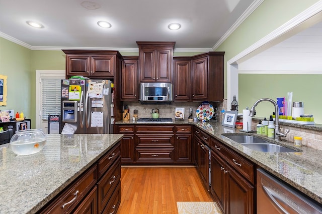 1811 Park Dr, Columbus, GA 31906 - kitchen with stainless steel appliances, light wood-type flooring, tasteful backsplash, light stone counters, and ornamental molding
