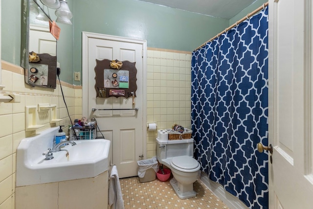 1811 Park Dr, Columbus, GA 31906 - full bathroom featuring tile walls, tile patterned flooring, vanity, a shower with shower curtain, and a wainscoted wall
