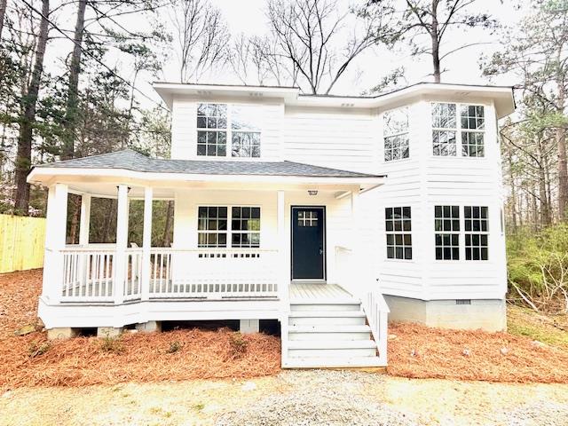 view of front of property featuring a shingled roof, covered porch, and crawl space