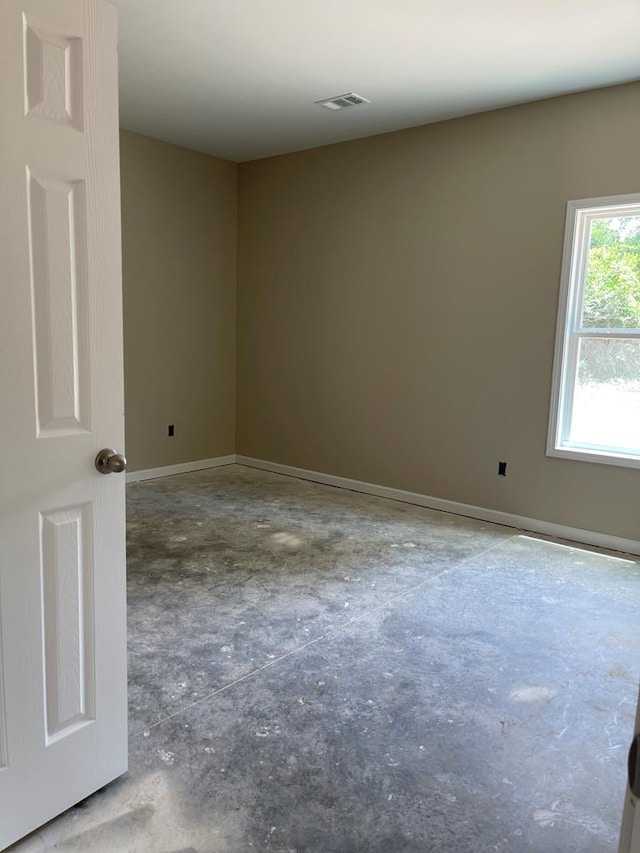 spare room featuring concrete flooring