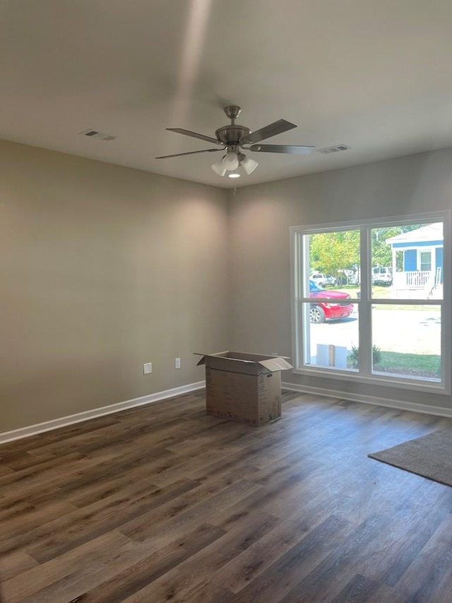 unfurnished room featuring ceiling fan and dark hardwood / wood-style flooring