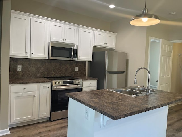 kitchen with white cabinetry, sink, a center island with sink, and appliances with stainless steel finishes