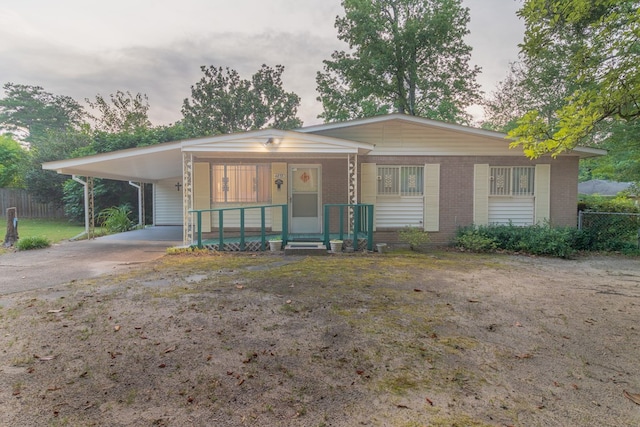 4833 Marino St, Columbus, GA 31907 - view of front of house featuring concrete driveway, brick siding, a porch, and a carport