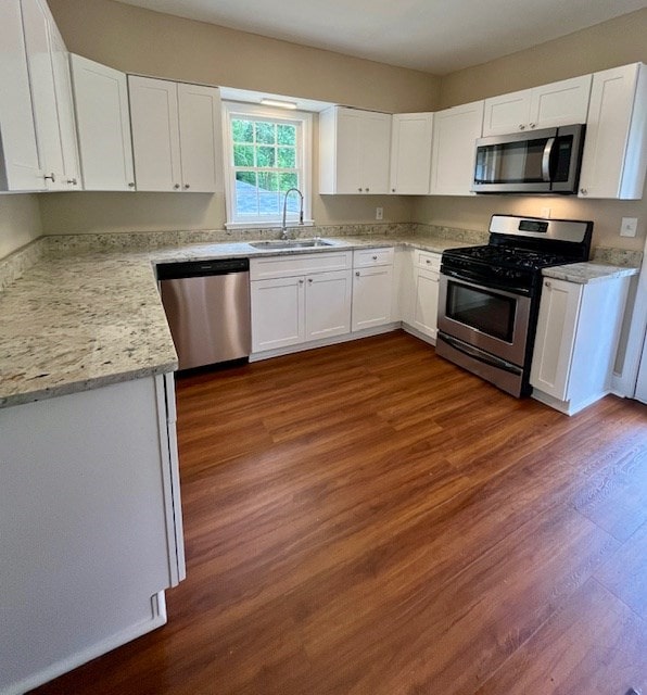 1555 Wells Dr, Columbus, GA 31906 - kitchen with stainless steel appliances, white cabinets, and dark wood-type flooring