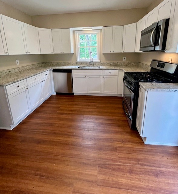 1555 Wells Dr, Columbus, GA 31906 - kitchen featuring appliances with stainless steel finishes, white cabinetry, and light stone counters