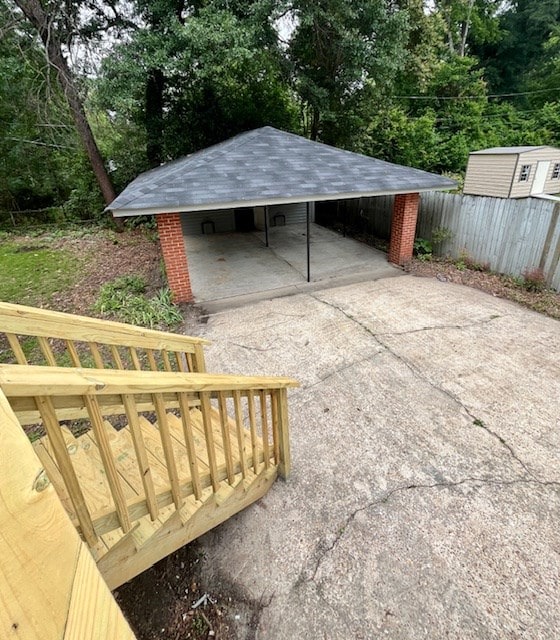 1555 Wells Dr, Columbus, GA 31906 - view of outdoor structure featuring driveway, a carport, and view of scattered trees