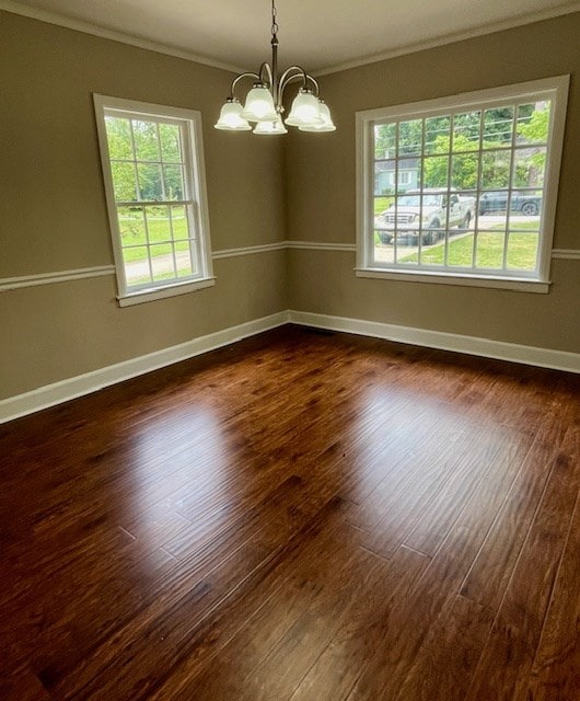 1555 Wells Dr, Columbus, GA 31906 - unfurnished room with ornamental molding, a chandelier, healthy amount of natural light, and dark wood-style floors