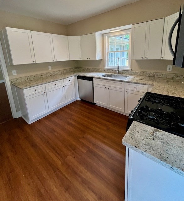 1555 Wells Dr, Columbus, GA 31906 - kitchen featuring dishwasher, dark wood-style flooring, white cabinetry, and light stone counters