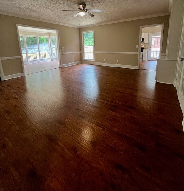 1555 Wells Dr, Columbus, GA 31906 - spare room featuring a ceiling fan, plenty of natural light, dark wood-style floors, ornamental molding, and a textured ceiling