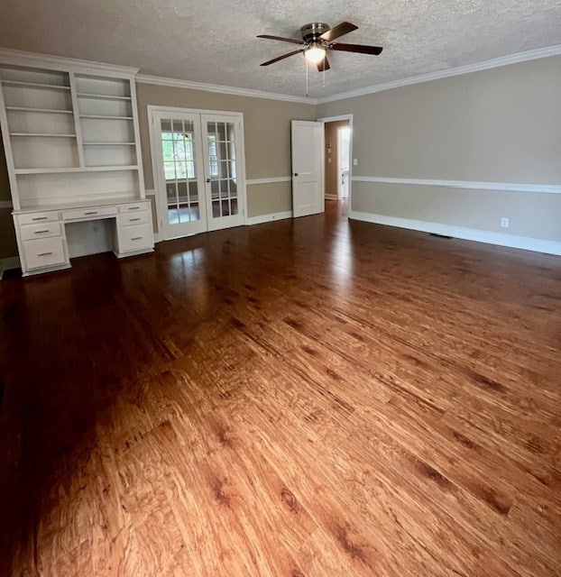 1555 Wells Dr, Columbus, GA 31906 - unfurnished living room featuring wood finished floors, french doors, ceiling fan, a textured ceiling, and built in desk