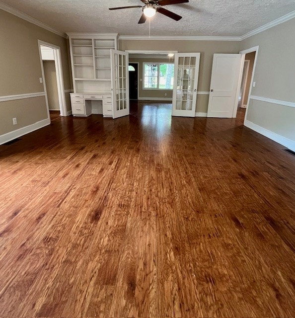 1555 Wells Dr, Columbus, GA 31906 - unfurnished living room with ceiling fan, wood finished floors, french doors, a textured ceiling, and ornamental molding