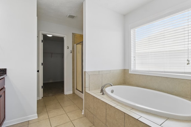 4685 Ivy Patch Dr, Fortson, GA 31808 - full bathroom with vanity, a stall shower, a bath, and tile patterned floors