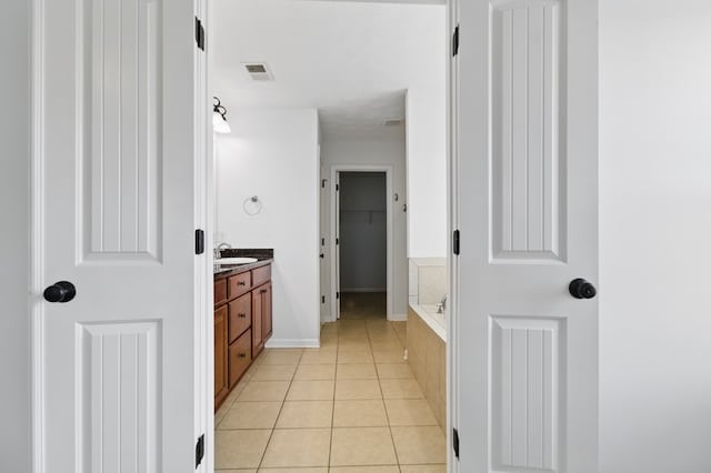4685 Ivy Patch Dr, Fortson, GA 31808 - full bathroom with vanity, tile patterned flooring, baseboards, and a spacious closet
