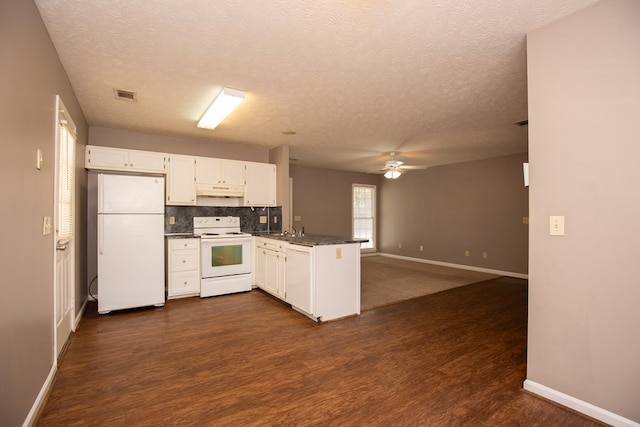 kitchen with white appliances, dark wood-type flooring, tasteful backsplash, white cabinets, and kitchen peninsula