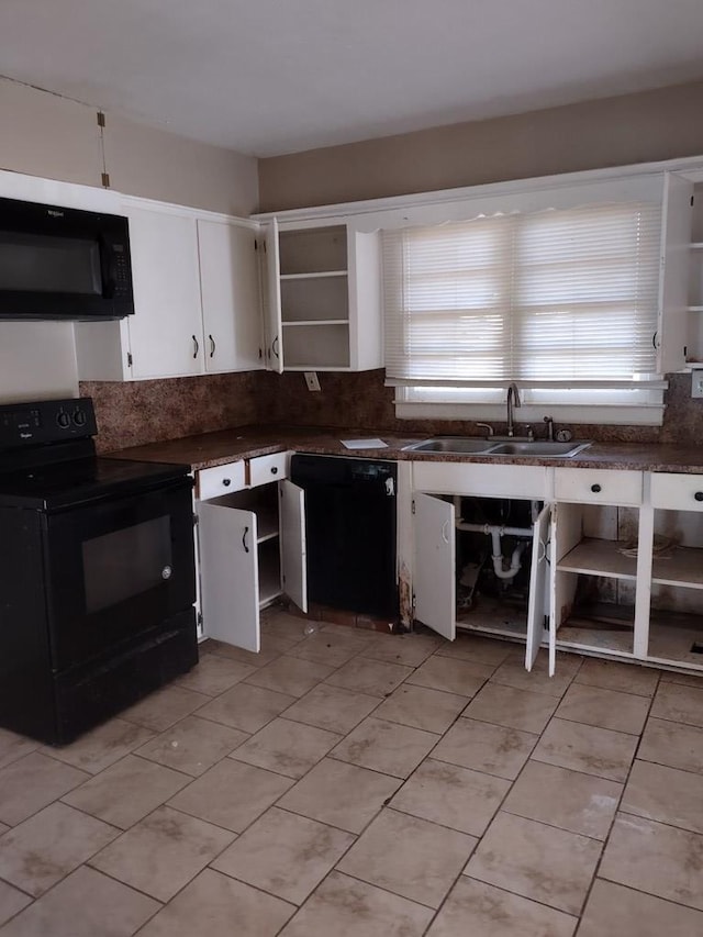 kitchen featuring decorative backsplash, sink, white cabinetry, and black appliances