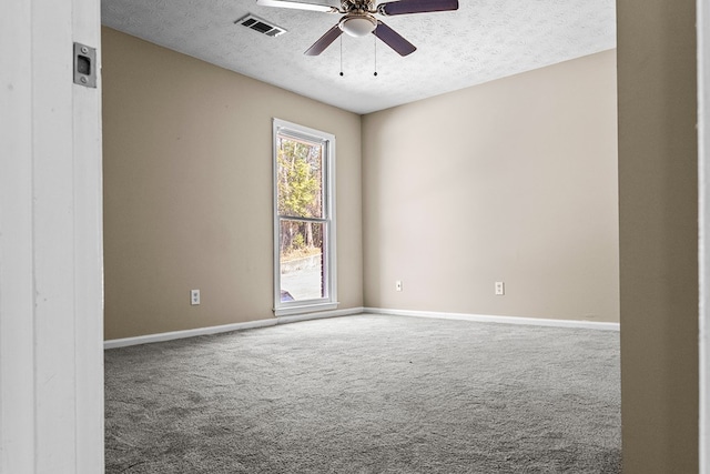 empty room featuring a ceiling fan, carpet flooring, a textured ceiling, and baseboards