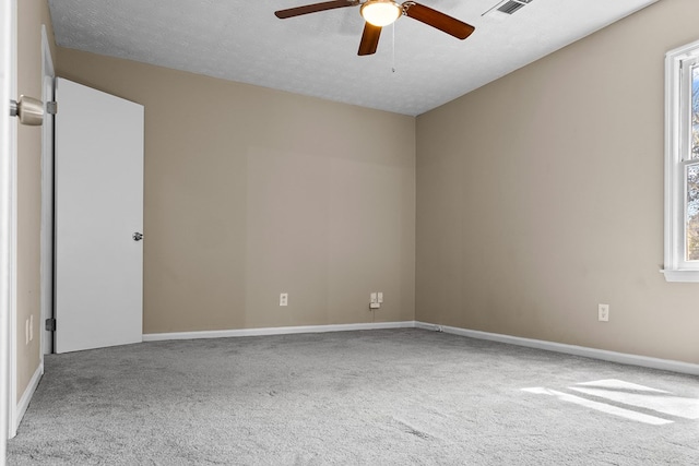 spare room with plenty of natural light, carpet, and visible vents