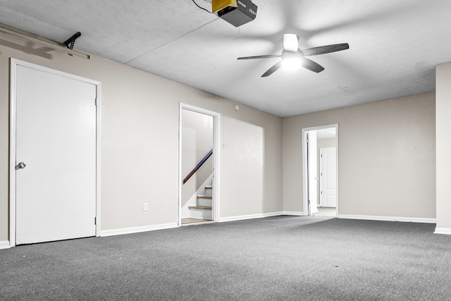 spare room with carpet, stairs, baseboards, and a ceiling fan