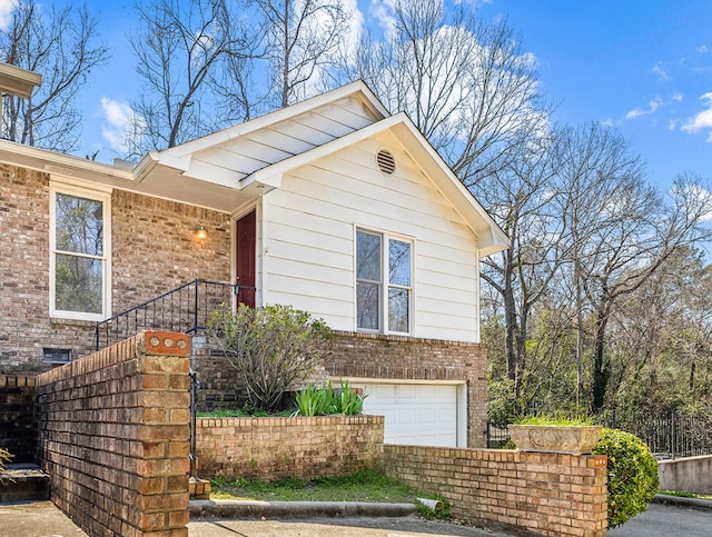 view of front facade with a garage and brick siding