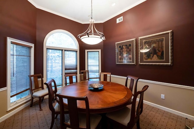 dining space with visible vents, baseboards, and crown molding