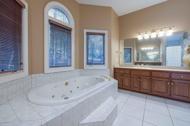 bathroom with vanity, a whirlpool tub, and tile patterned flooring