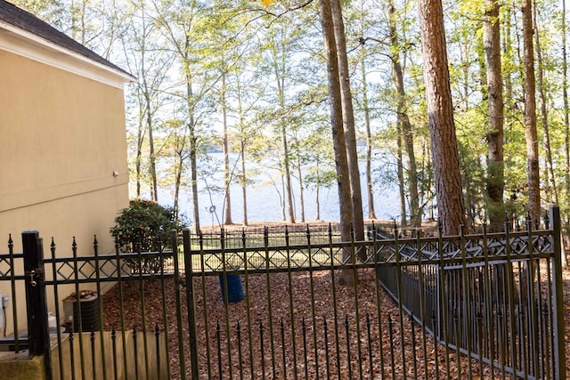 view of gate featuring fence private yard and central AC