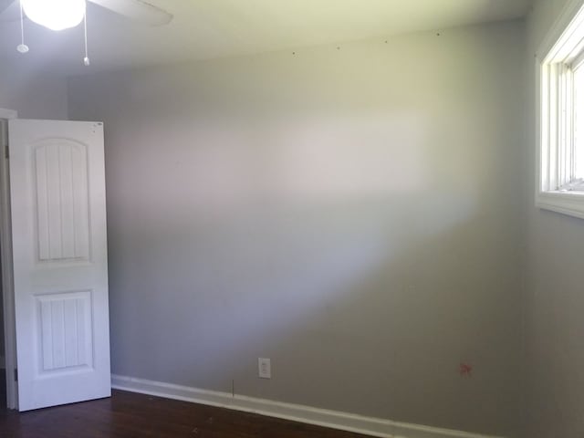 unfurnished room featuring ceiling fan and dark hardwood / wood-style flooring