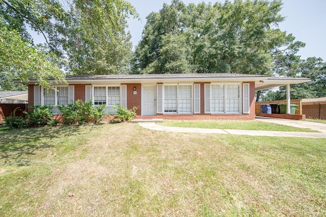 single story home featuring a front yard and a carport