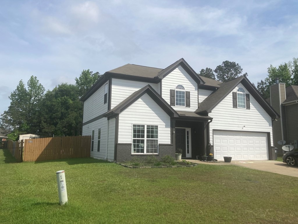 5TRAFFORDTRL Trafford Trl, Phenix City, AL 36870 - traditional home with an attached garage, fence, driveway, and a front yard