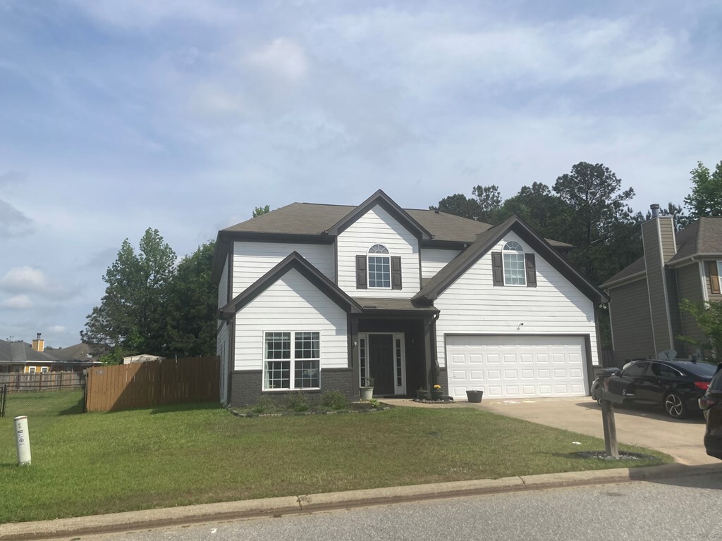5TRAFFORDTRL Trafford Trl, Phenix City, AL 36870 - traditional-style home featuring an attached garage, a front lawn, fence, and driveway