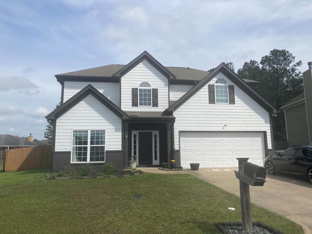 5TRAFFORDTRL Trafford Trl, Phenix City, AL 36870 - traditional-style house featuring a front yard, brick siding, fence, concrete driveway, and an attached garage