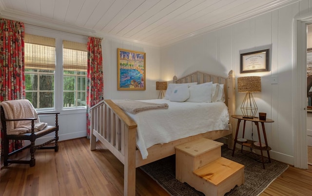 bedroom featuring wood ceiling, crown molding, and wood finished floors